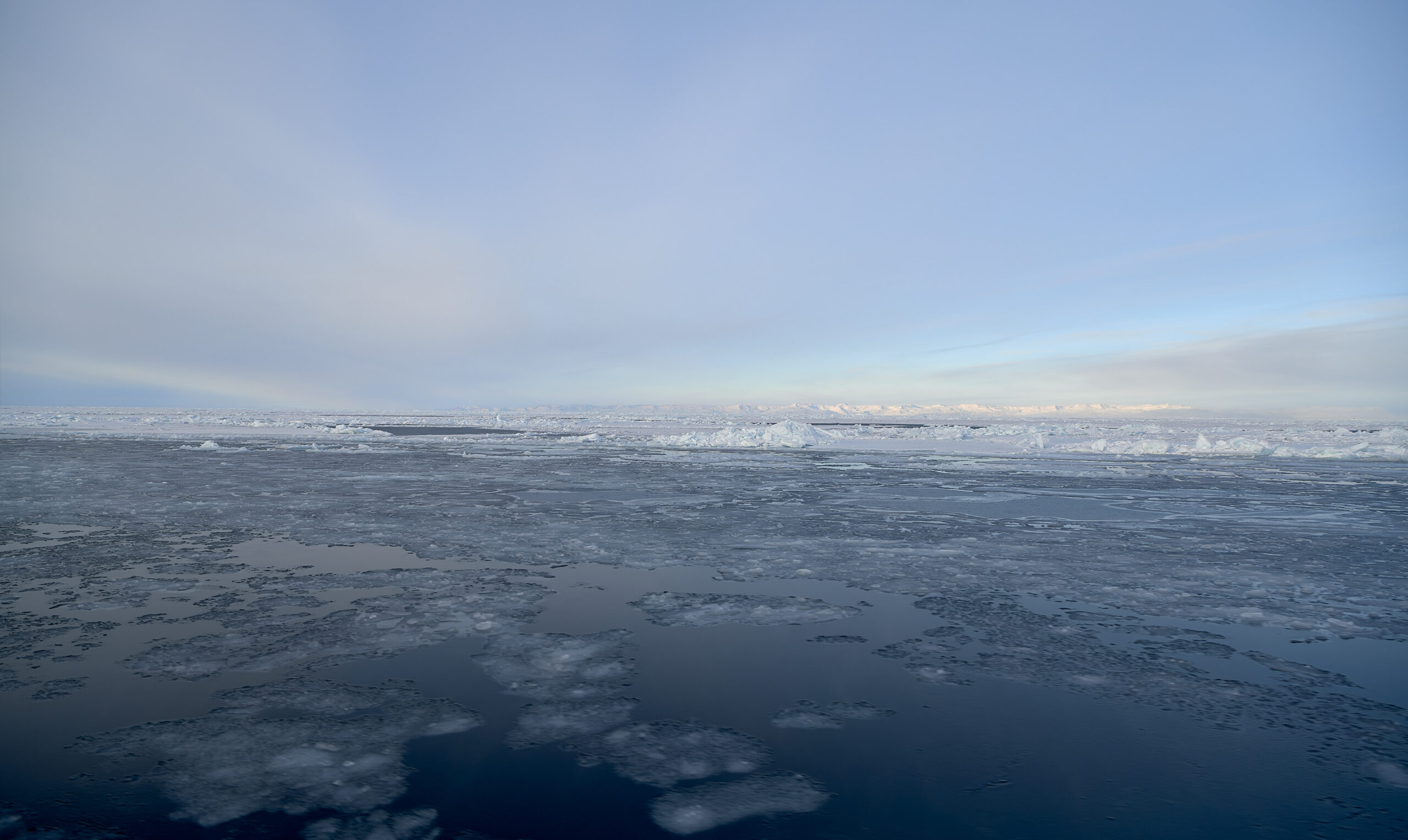 The Arctic Ocean of Disko Bay near Ilulissat, with the island of Qeqertarsuaq on the horizon.