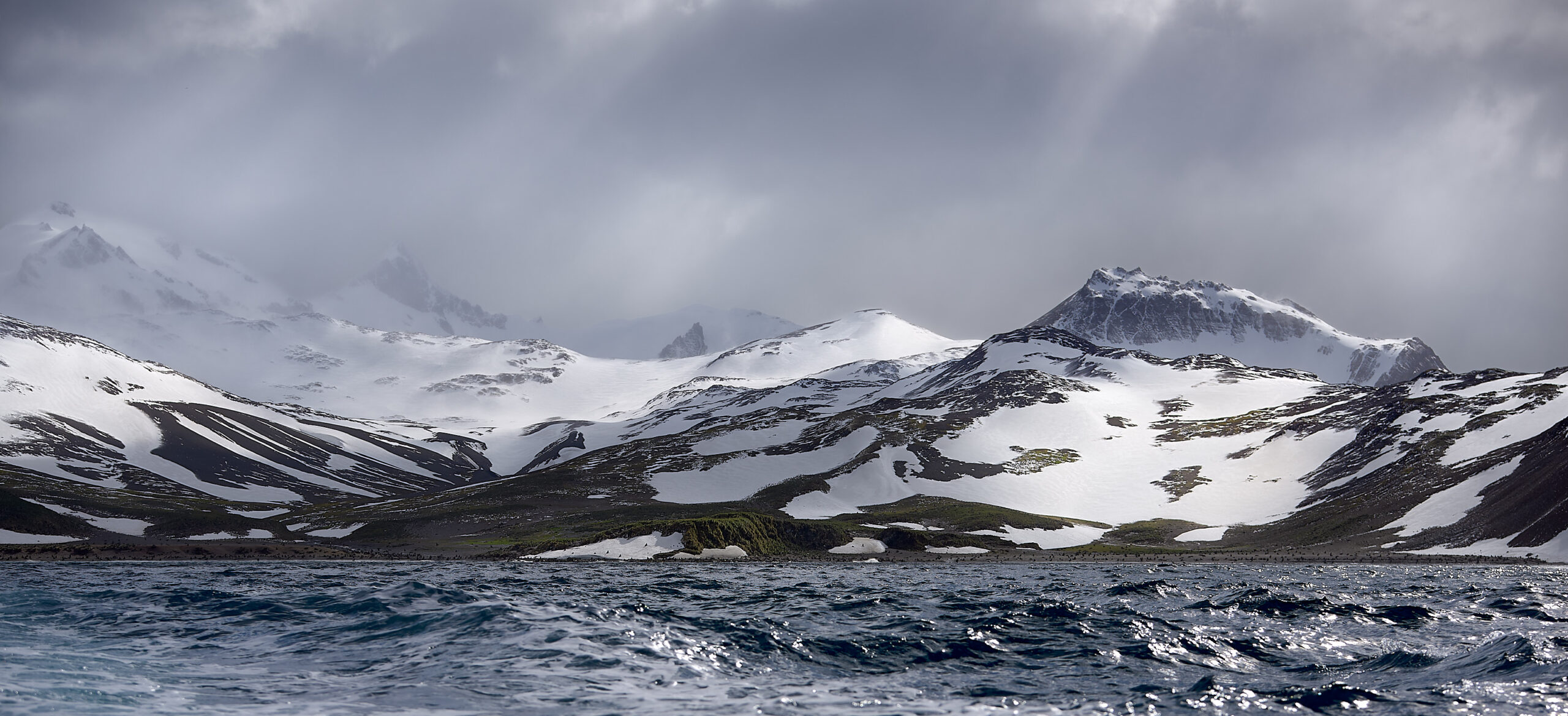 The snow-covered mountain panorama of Rosita Harbour in the west of the large Bay of Isles on the north coast of South Georgia.