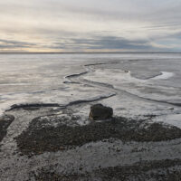 View of the bay Skarðsfjörður behind the Austurfjörur spit east of Höfn near the Stokksnes headland below the famous Vestrahorn mountain on the south coast of Iceland.